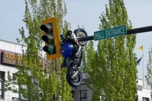 Vancouver crash leaves motorcycle dangling overhead on traffic light