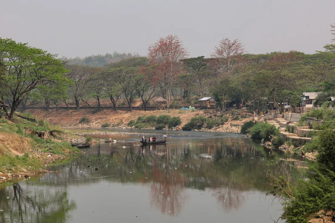 People travel on a boat between no man's land and Myanmar near the Thai border, amid a mounting crackdown on scam centres operating along a porous border, in Mae Sot District, Tak province, Thailand February 21, 2025. REUTERS/Chalinee Thirasupa