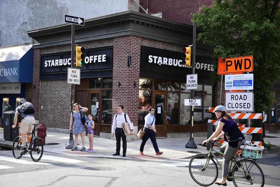 Pedestrians walk by the Starbucks in Philadelphia where two black men were arrested in May 2018.