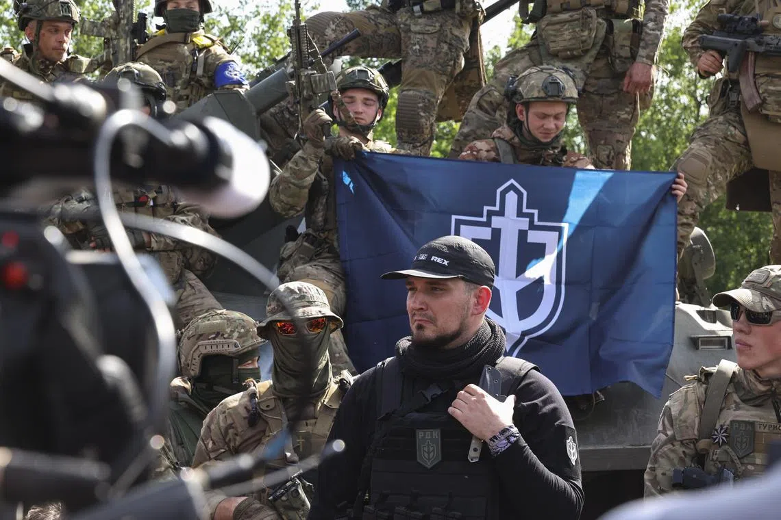 Russian Volunteer Corps leader Denis Kapustin (centre) meets the media not far from the Ukraine-Russia border, in Ukraine's Kharkiv region.
