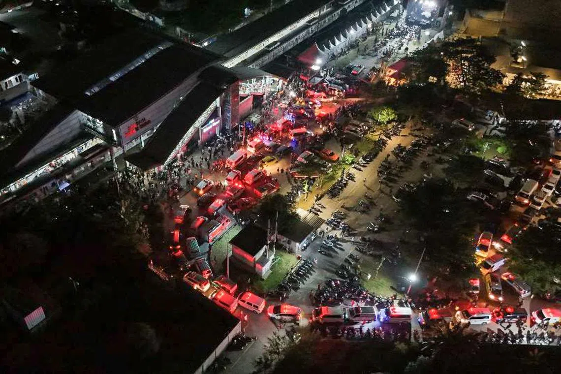 An aerial photograph showing ambulances gathering after one train collided with another at Bekasi Timur train station in Bekasi 
