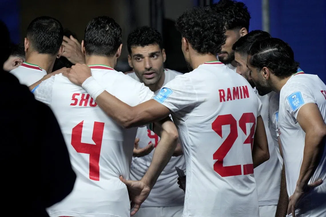 Iran captain Mehdi Taremi of Iran speaks to his teammates during a World Cup match on June 26.