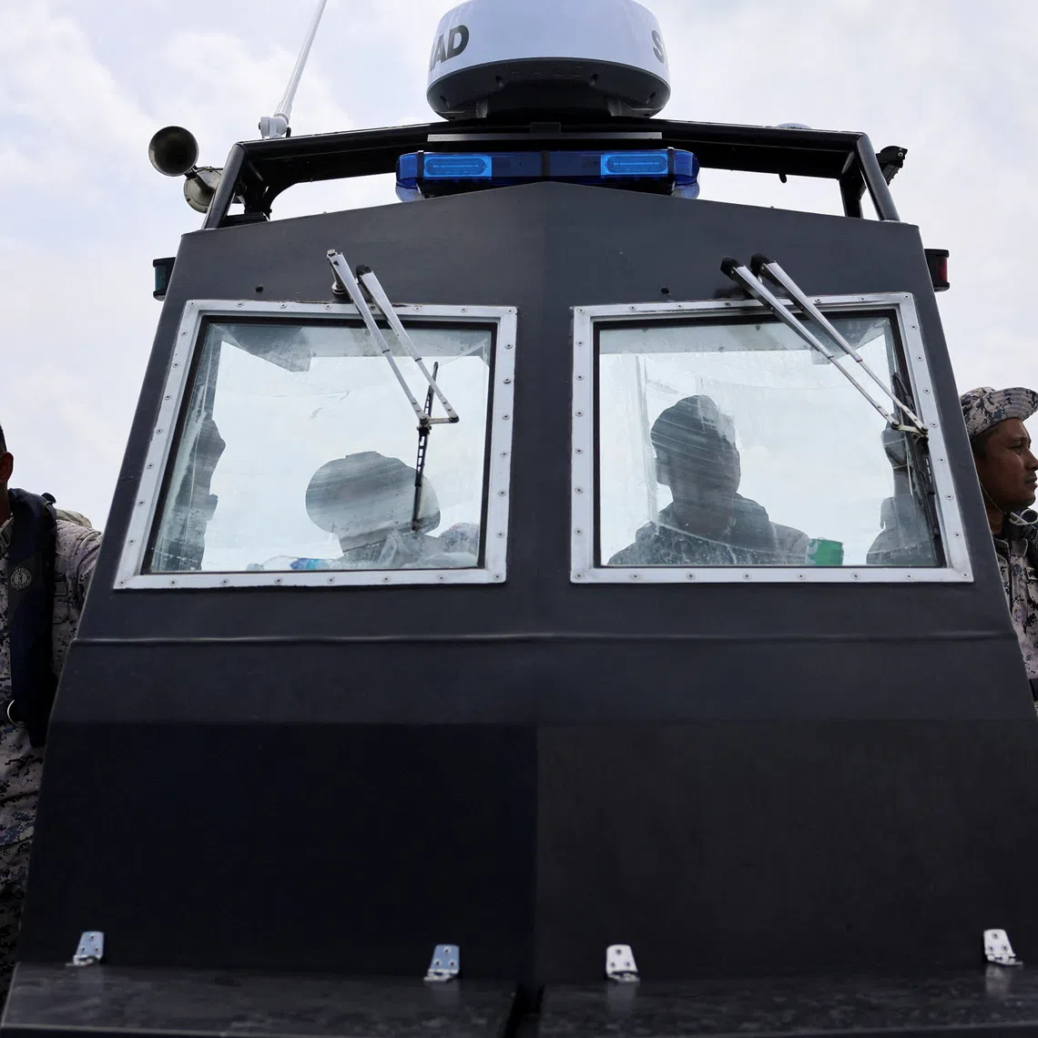 Malaysian Maritime Enforcement Agency officers search for victims during a search and rescue operation.