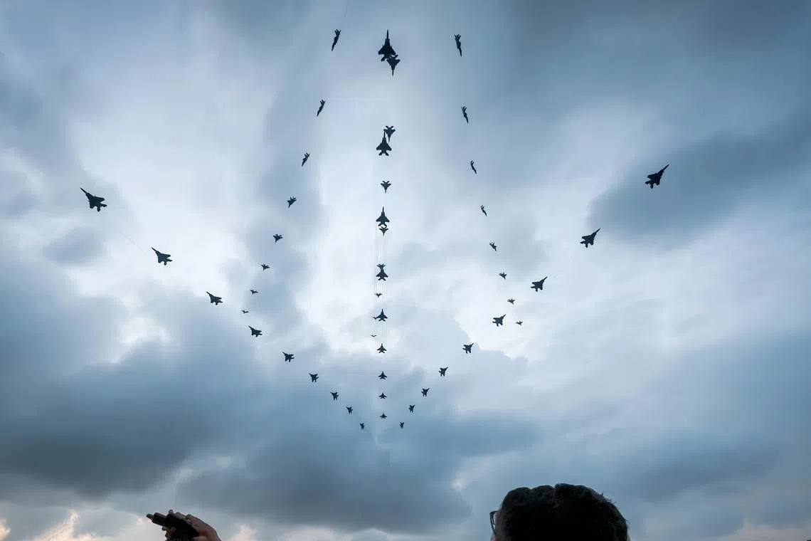 F-15SG fighters in a multi-axis fly-past, as seen in a composite image from the Marina Bay Sands SkyPark Observation Deck on Aug 9.