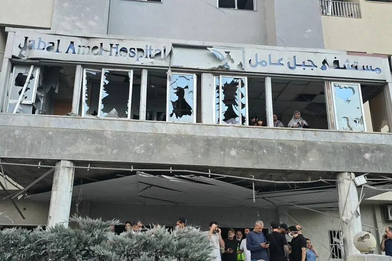 People gathering at a hospital that was damaged after an Israeli strike hit at a site nearby in the southern Lebanese city of Tyre on June 1.