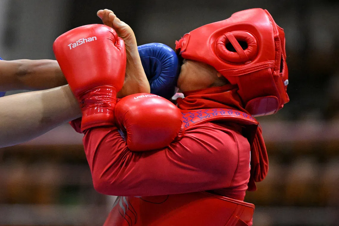 Sogand Sinkaeichetan (right) of Iran gets kicked in the face by Aparna of India during the Women's 52kg Sanda quarterfinals held at the Aichi Prefectural Martial Arts Hall on Sept 20, 2026.