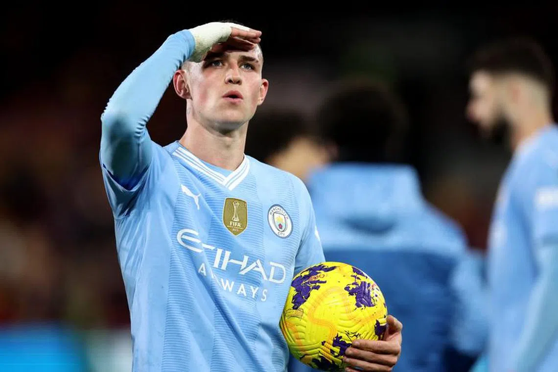 Soccer Football - Premier League - Brentford v Manchester City - Brentford Community Stadium, London, Britain - February 5, 2024 Manchester City's Phil Foden celebrates with the match ball after completing a hat-trick REUTERS/David Klein
