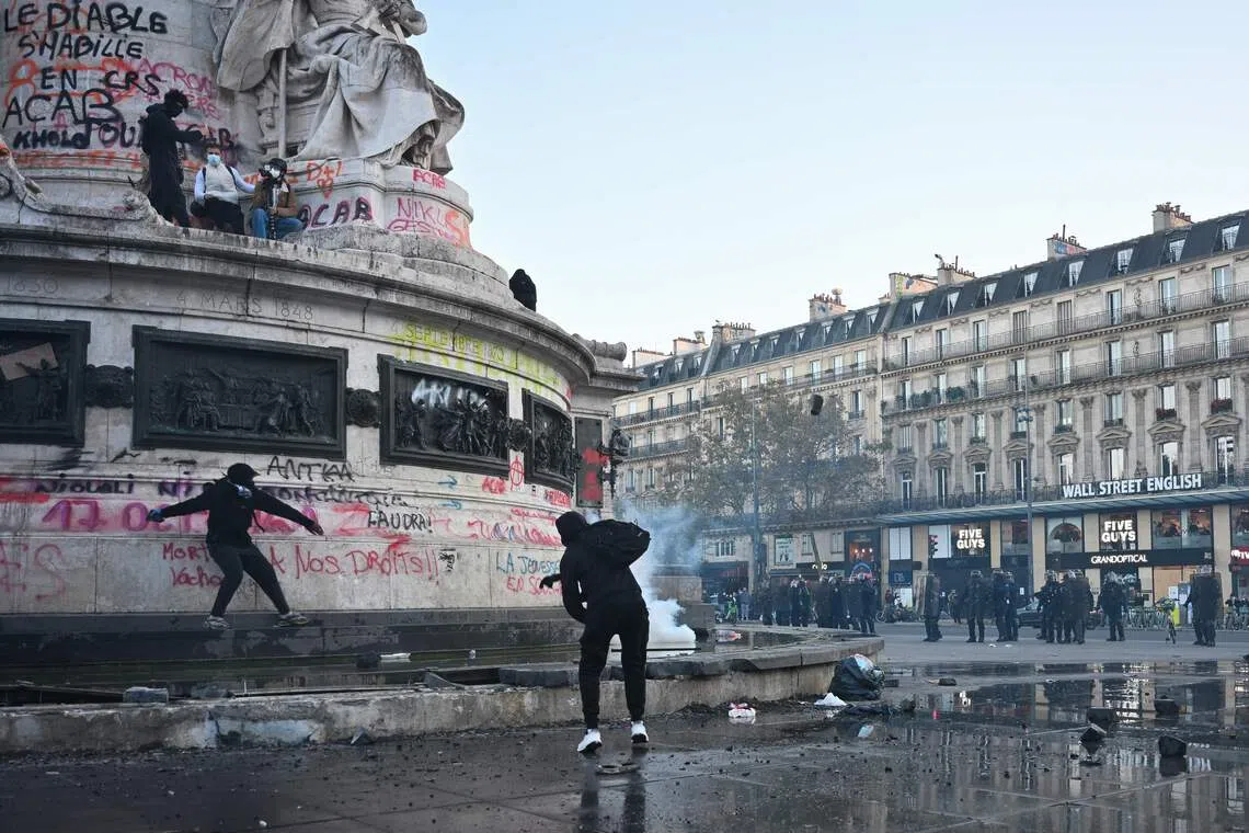 Protesters break up the fountain at the base of the Statue de La Republique to get stones as clashes erupted at Place de la Republique in Paris, on Oct 18.