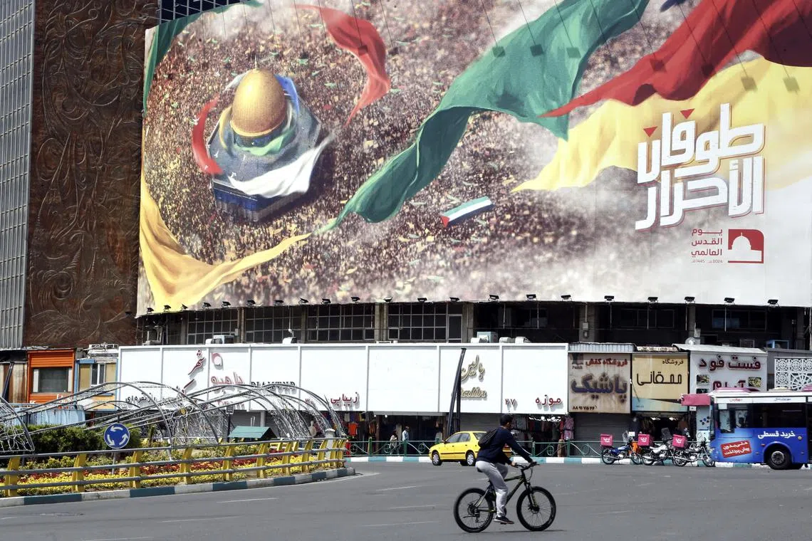 epa11274436 An Iranian passes an anti-Israel billboard in Tehran, Iran, 12 April 2024. According to the Iranian supreme leader's official website, Khamenei said on 10 April that Israel 'should be punished and it will be punished' following the recent airstrike on the Iranian consulate in Syria which Iran blames on Israel.  EPA-EFE/ABEDIN TAHERKENAREH