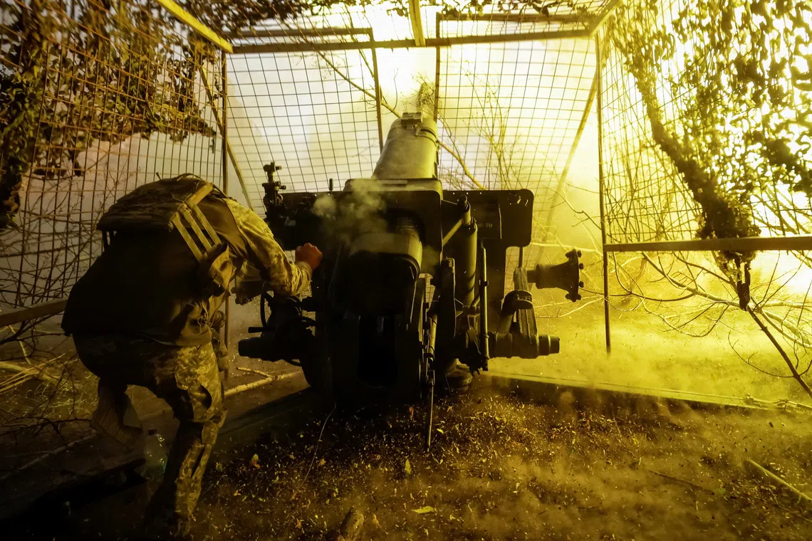 A Ukrainian soldier fires a D-30 howitzer towards Russian troops near the front line town of Kupiansk in Kharkiv region, Ukraine.