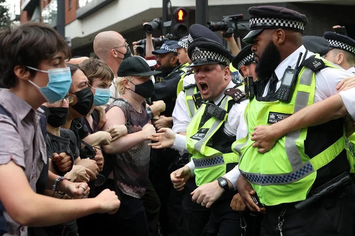 Police officers clashing with counter protesters in London in an attempt to move them off the street, as an anti-immigration march takes place outside the Barbican Thistle hotel on Aug 2.