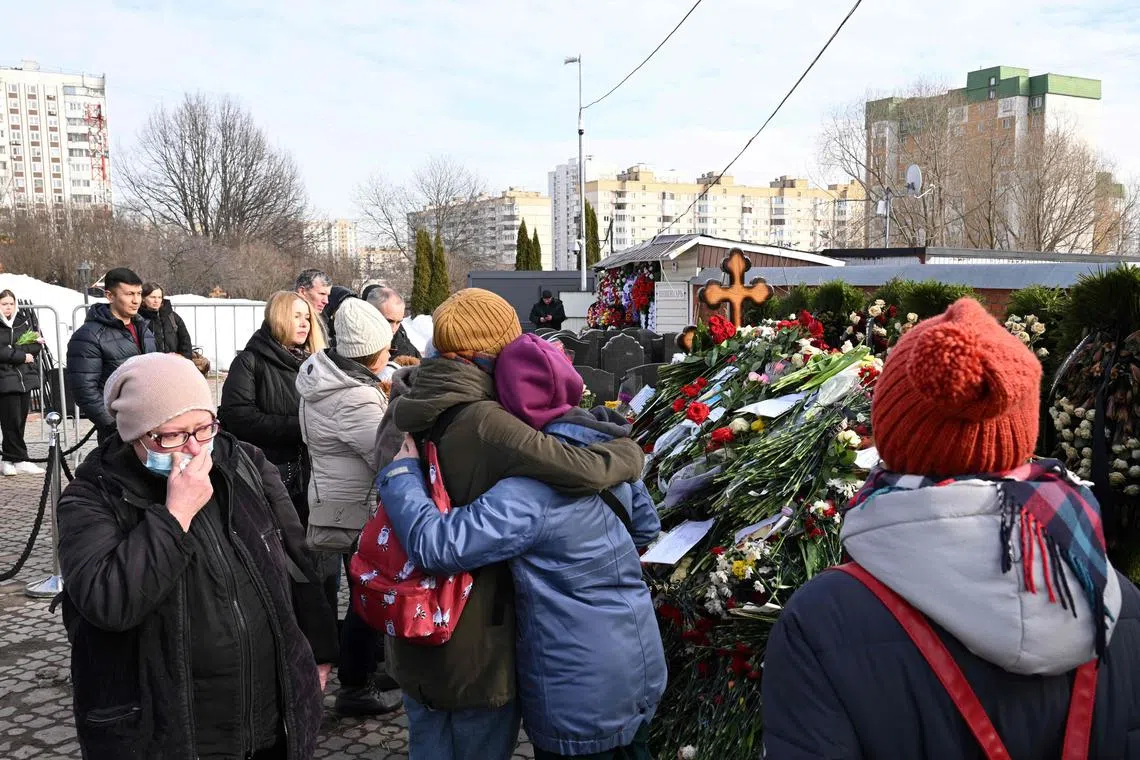 Mourners visit the grave of late Russian opposition leader Alexei Navalny at the Borisovo cemetery in Moscow.
