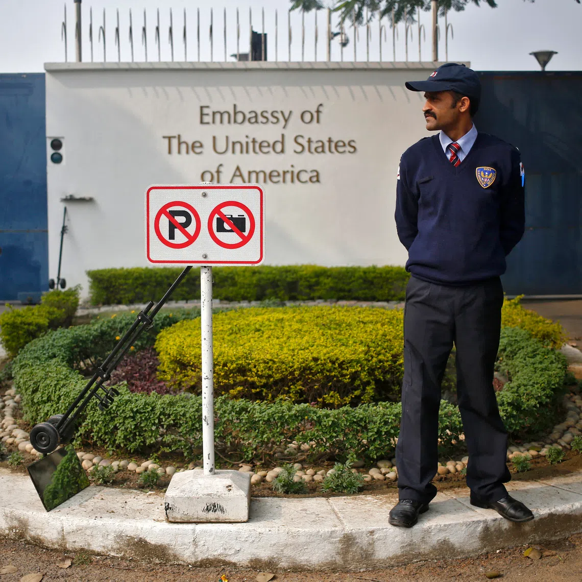FILE PHOTO: A private security guard stands outside the U.S. embassy in New Delhi December 18, 2013. REUTERS/Anindito Mukherjee/File Photo