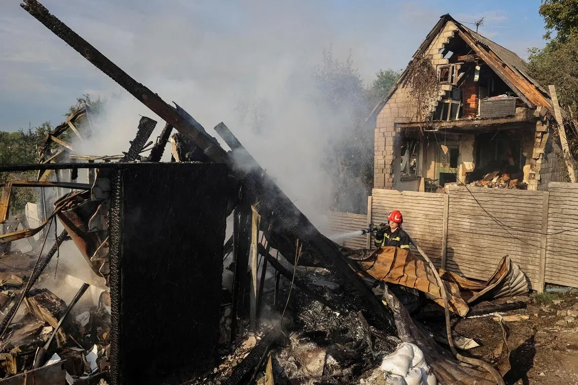 A firefighter works at the site of a Russian missile strike, amid Russia's attack on Ukraine, in the village of Sknyliv on the outskirts of Lviv, Ukraine August 21, 2025. REUTERS/Roman Baluk