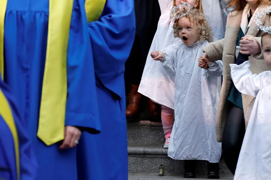 Mollie Berry from St. Joseph's nursery reacting as she sings alongside Lucan Gospel Choir at a live animal Christmas nativity crib, in Dublin, Ireland, Dec 11, 2024. 