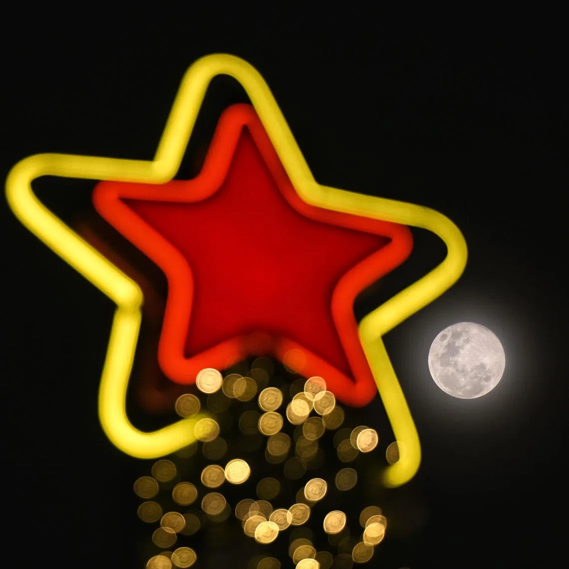 The Cold Moon juxtaposed with a Christmas Tree in Orchard on Dec 15, 2024.
