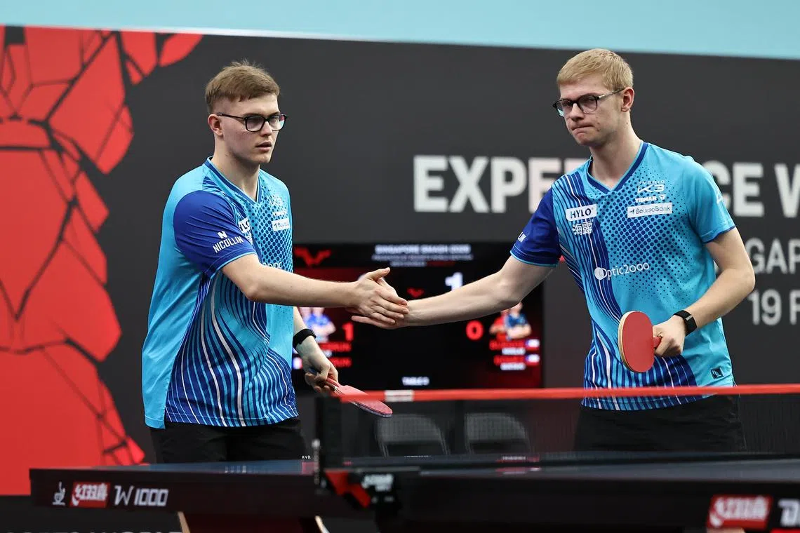 Brothers Alexis (left) and Felix Lebrun exchanging high fives during their men's doubles round-of-16 match at the Singapore Smash on Feb 24.