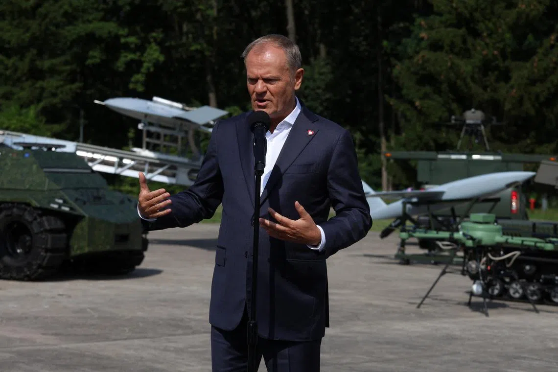 FILE PHOTO: Poland's Prime Minister Donald Tusk speaks during a press conference after a briefing with the management of military institutes at the Air Force Institute of Technology in Warsaw, Poland, July 30, 2025. Robert Kowalewski/Agencja Wyborcza.pl via REUTERS/File Photo