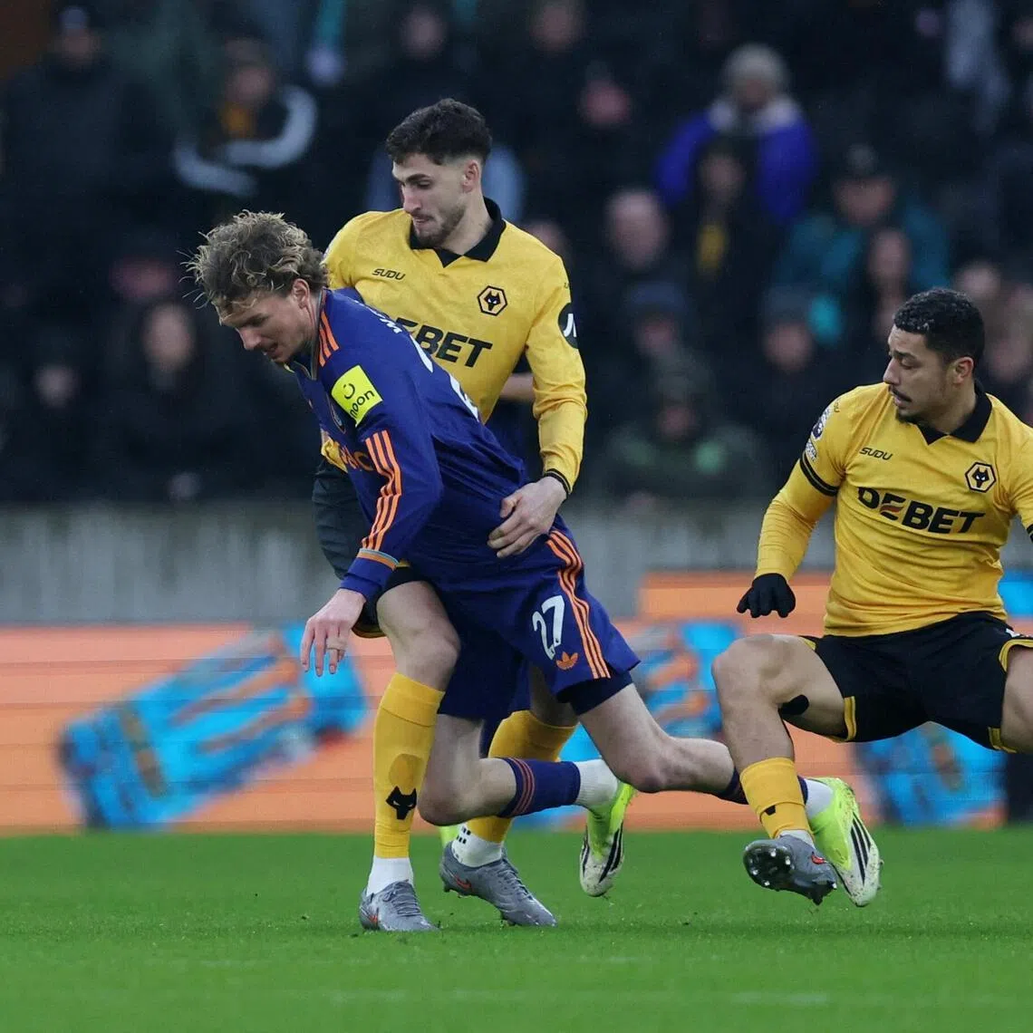 Newcastle United's Nick Woltemade in action with Wolverhampton Wanderers' Andre and Santiago Bueno during the 0-0 English Premier League draw at Molineux on Jan 18, 2026.
