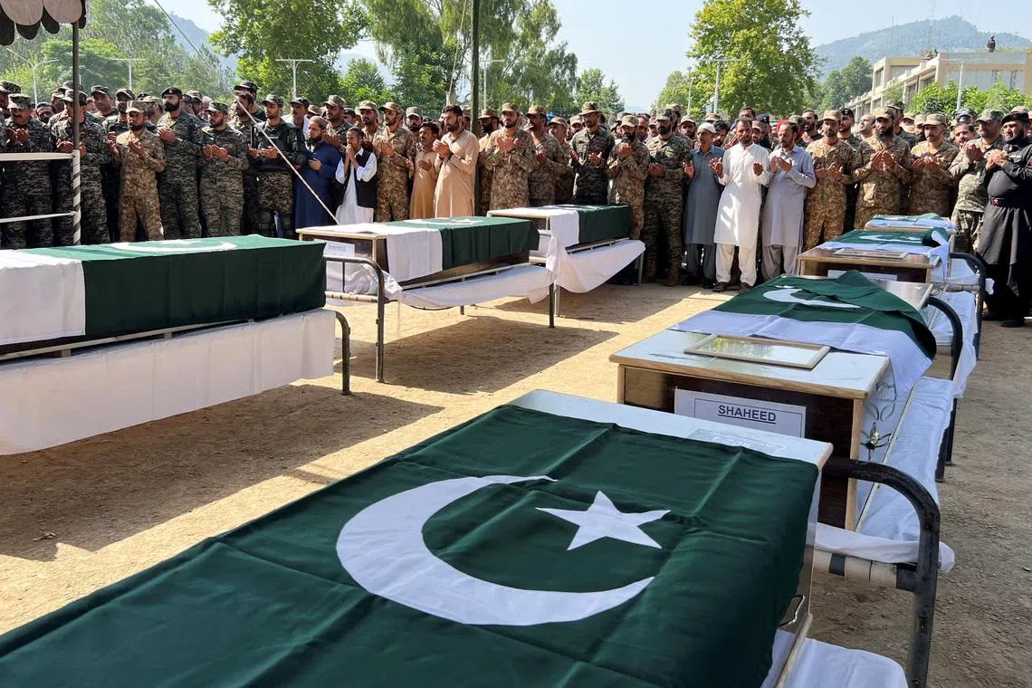 Pakistani Army officers and people offer prayers as they attend the funeral of the victims, who died after an Mi-17 helicopter of Pakistan Army Aviation crashed near Muzaffarabad on Wednesday during take-off, in Muzaffarabad, Pakistani Kashmir, June 11, 2026. Picture taken with a mobile phone. REUTERS/Naseer ud Din