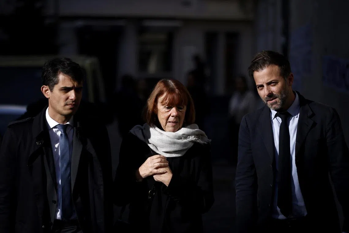 Gisele Pelicot (centre), escorted by her lawyers Stephane Babonneau (left) and Antoine Camus, walking to the criminal court in Avignon, France on Nov 26. 