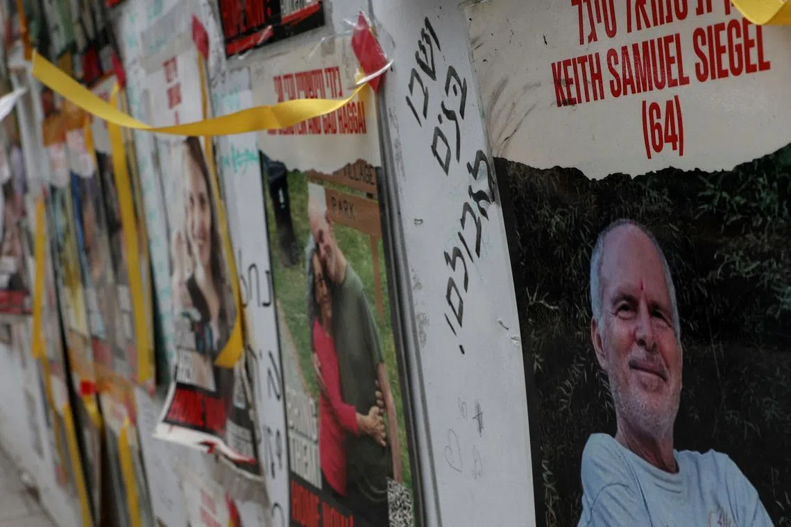 FILE PHOTO: A view of a banner depicting Keith Siegel, who is a dual U.S. citizen seized during the October 7 attack on Israel and taken hostage into Gaza, amid the ongoing conflict between Israel and Hamas, is seen with other images of hostages in Tel Aviv, Israel, April 28, 2024. REUTERS/Shannon Stapleton/File Photo