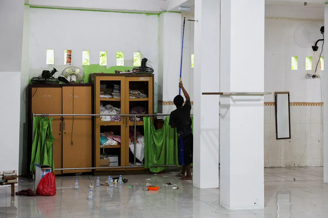 A worker works inside a mosque where explosions occurred the previous day, at a school complex in Jakarta, Indonesia, November 8, 2025. REUTERS/Willy Kurniawan