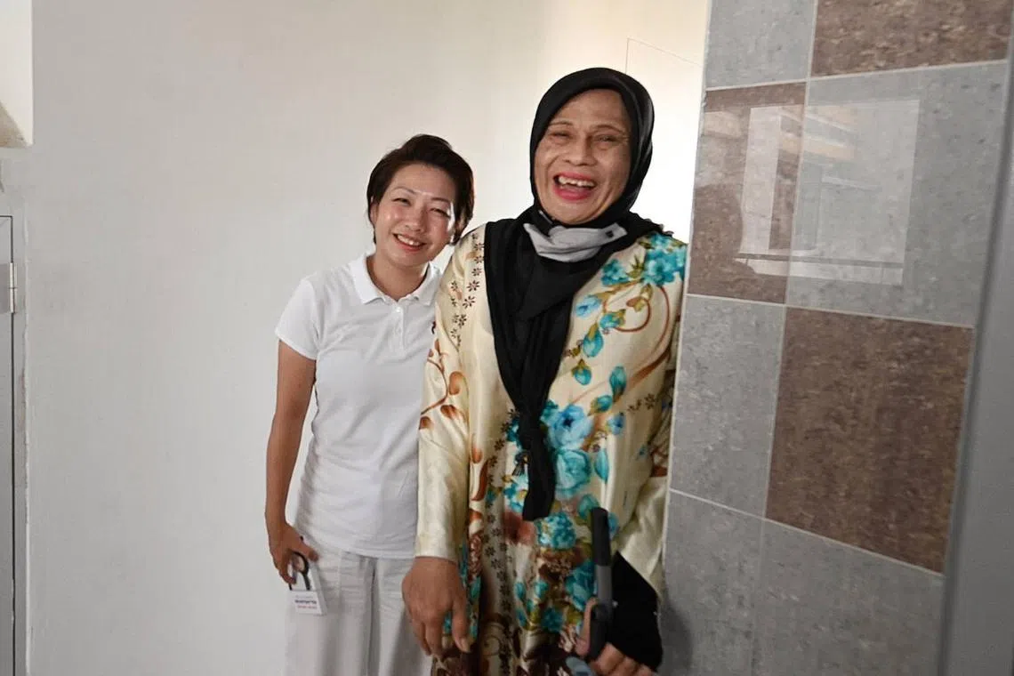 The PAP's Mountbatten candidate Gho Sze Kee with Pine Close estate cleaner Lana Abdul on April 29.