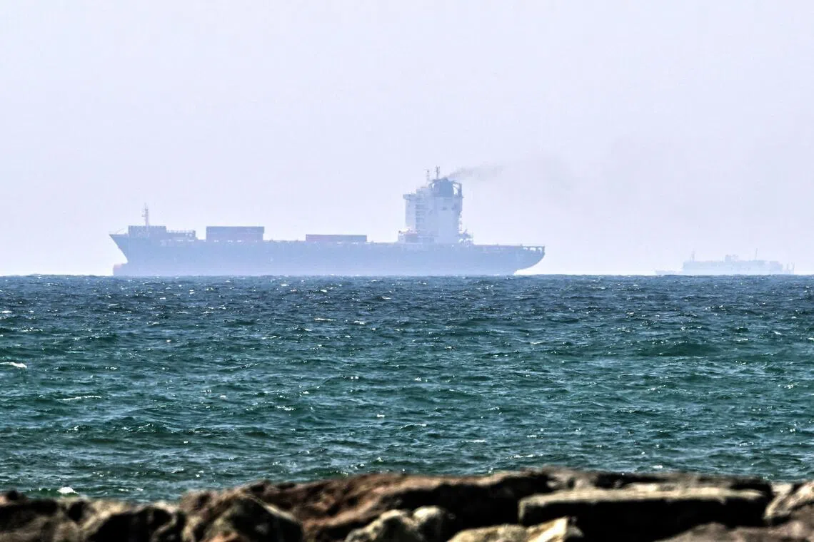 Vessels are seen off the coast of Sharjah in the United Arab Emirates on May 21. Due to the Iran war, 20,000 seafarers remain stranded inside the Gulf on board hundreds of ships.