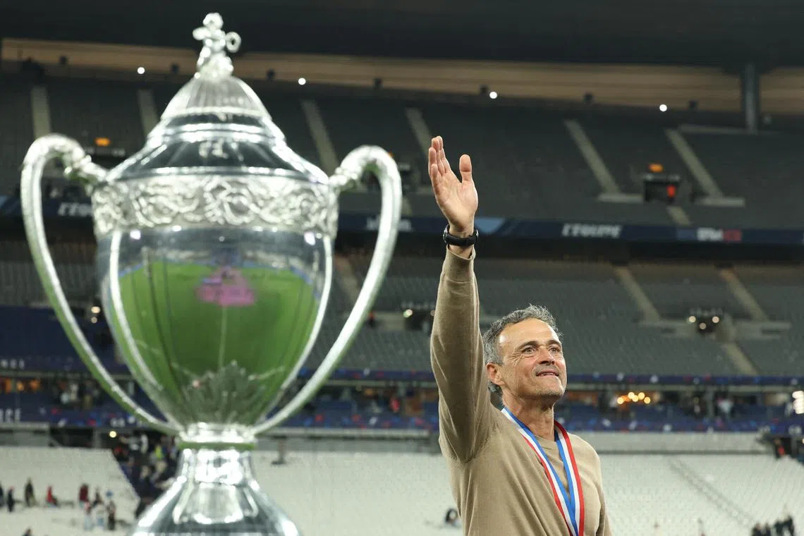 PSG coach Luis Enrique celebrates after winning the Coupe de France.