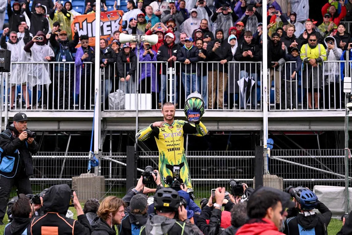 Australian rider Jack Miller gestures to the crowds after a farewell lap following the cancellation of the last Australian MotoGP Grand Prix to be held at Phillip Island on Oct 25 due to inclement weather conditions.