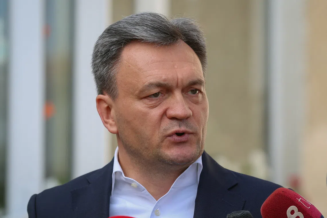 Moldova's Prime Minister Dorin Recean speaks to the media after voting at a polling station during the country's parliamentary elections in Chisinau, Moldova September 28, 2025.  REUTERS/Stringer