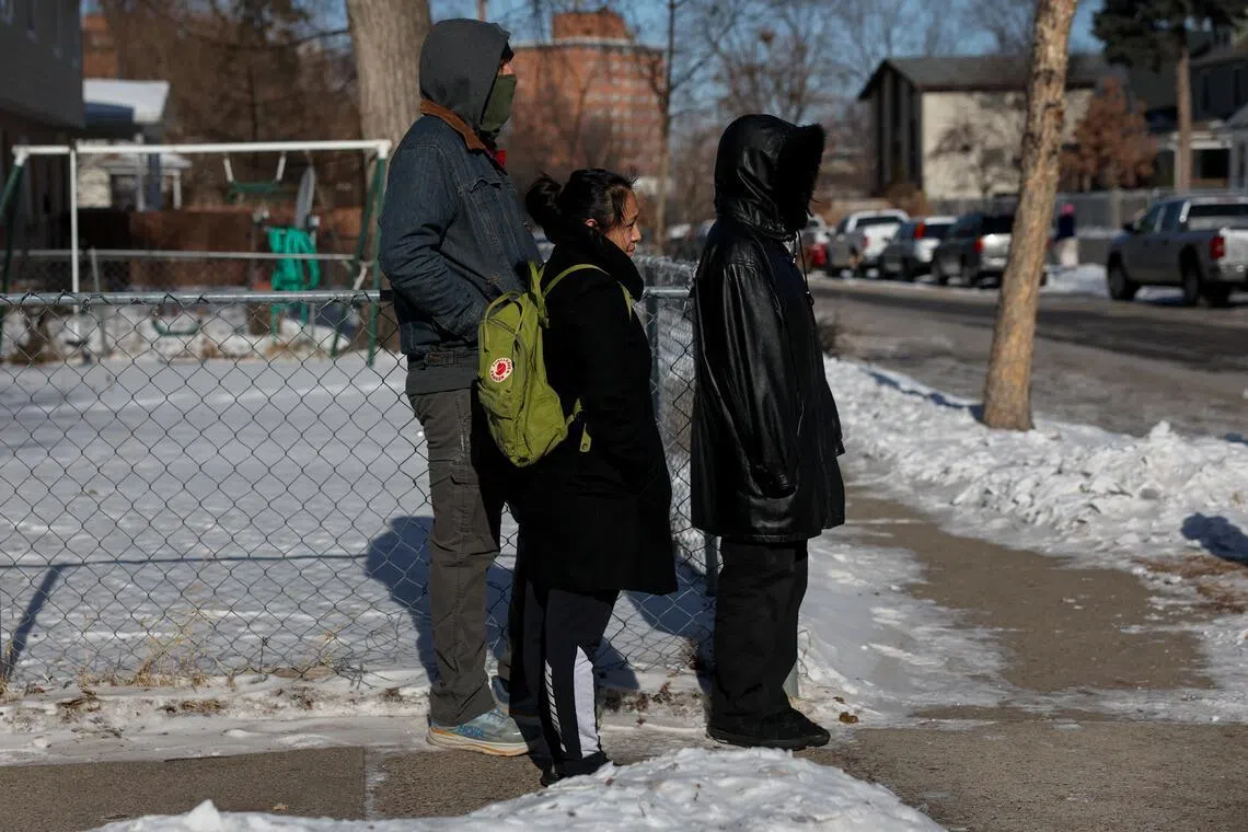 Residents stand as local community activists alert neighbours about an SUV with tinted windows, which observers believe to be a federal law enforcement vehicle, after Mr Alex Pretti was fatally shot by federal immigration agents trying to detain him on Jan 24, 2026.