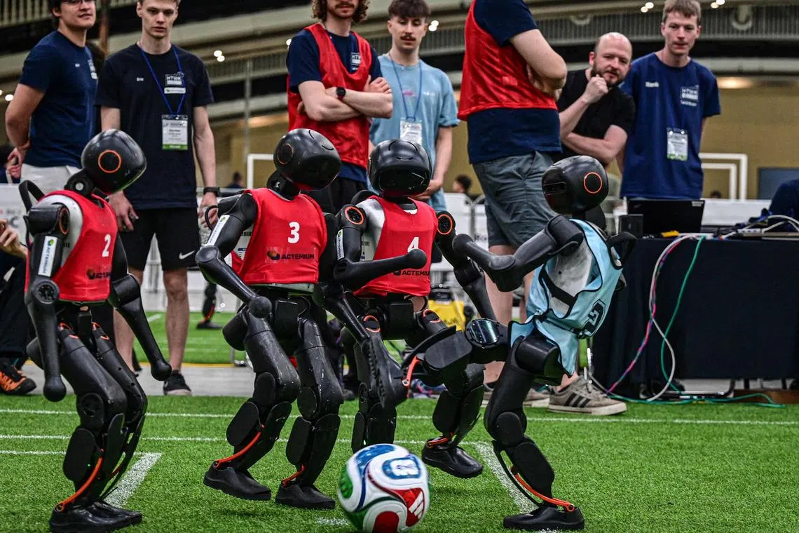 Robots take part in a football match at RoboCup 2026, a robotics and Artificial Intelligence (AI) competition in Incheon on July 3, 2026. (Photo by Jade GAO / AFP)