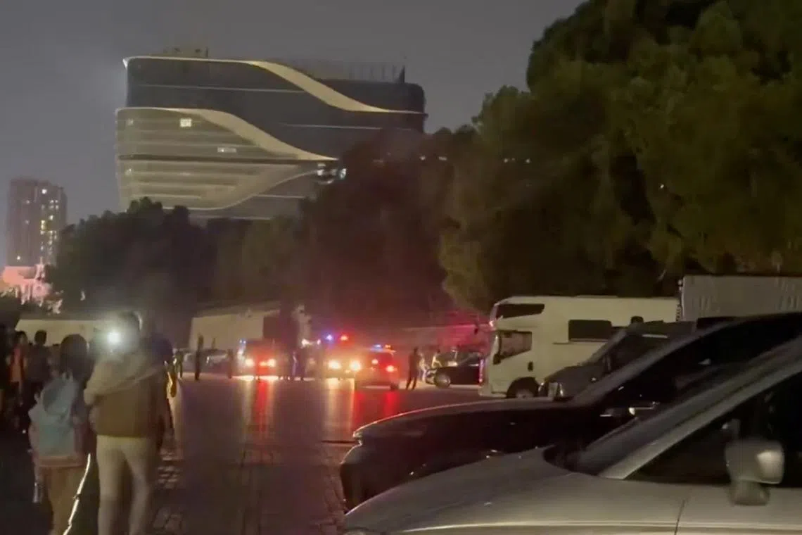 Emergency personnel work near the site of a suspected hit-and-run attack, which left several wounded, outside a sports centre, in Zhuhai, China, November 11, 2024, in this still image taken from a social media video. Social Media/via REUTERS