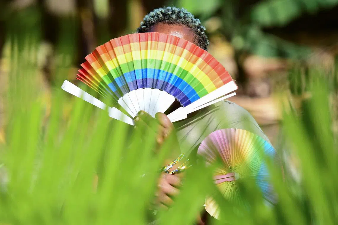 Quin Karala, 29, a member of the lesbian, gay, bisexual, transgender, intersex and queer (LGBTQ) community and a single mother of one poses for a picture with rainbow colours at the offices of Rella Women's Empowerment Program, for LGBTQ rights advocacy, after a Reuters interview in Kulambiro suburb of Kampala, Uganda April 4, 2023. REUTERS/Abubaker Lubowa/  File Photo