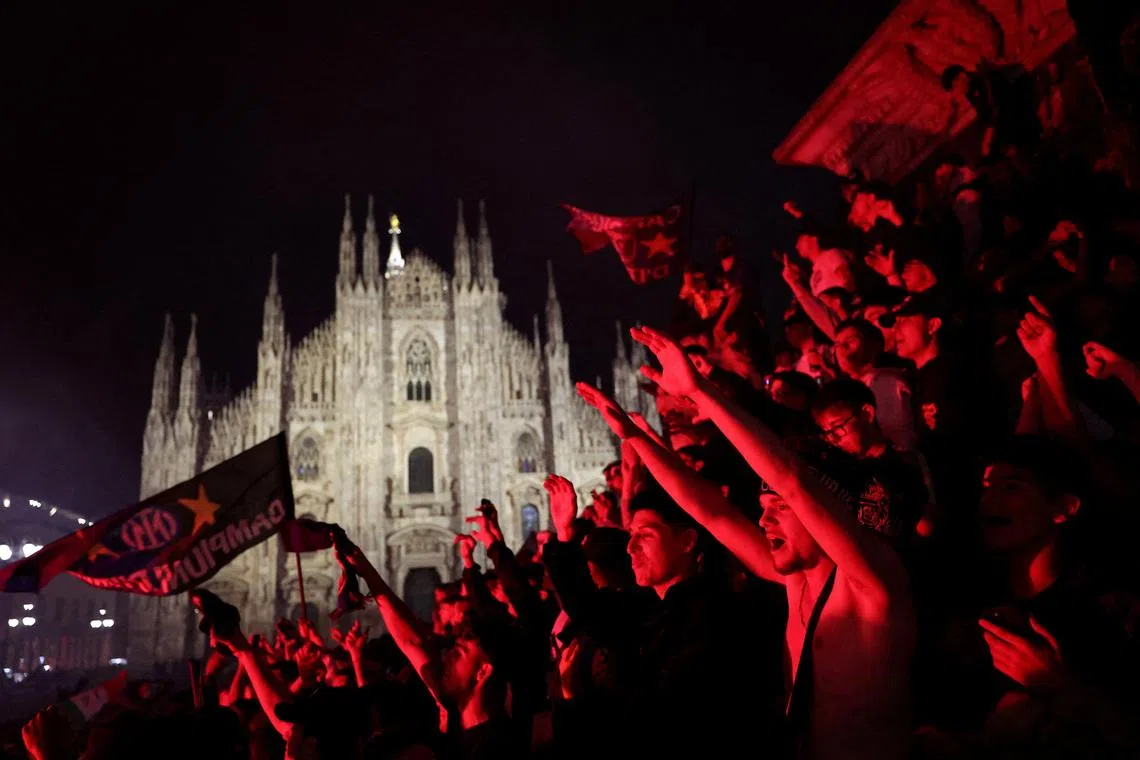 Inter Milan football fans celebrate winning the Serie A at the Duomo Square in Milan, Italy, May 3.