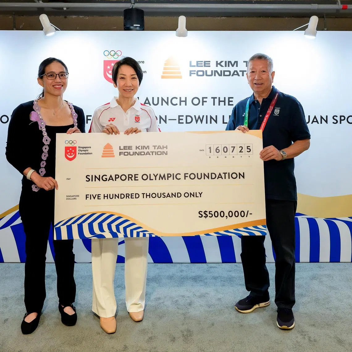 Nicole Lee (left), daughter of the late veteran sports administrator Edwin Lee, presents a $500,000 check on behalf of the Lee Kim Tah Family Foundation to SOF Chairman Ng Ser Miang (right), with SNOC President Grace Fu (center) witnessing. The donation will be used to fund the new SOF-Edwin Lee Yong Chuan Sports Fund, which aims to support the advancement of competitive sports in Singapore. 

Photo: Andy Chua / Singapore Olympic Foundation 
