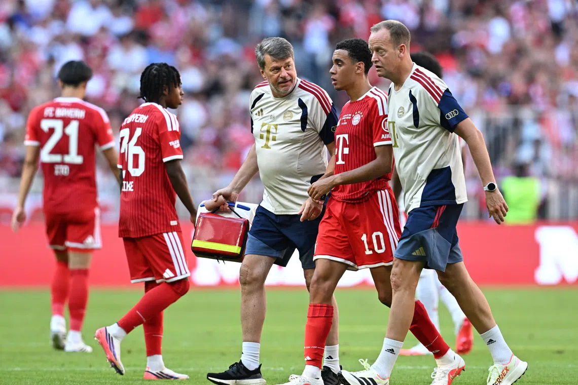 Soccer Football - Pre Season Friendly - Bayern Munich v RB Leipzig - Allianz Arena, Munich, Germany - August 15, 2026 Bayern Munich's Jamal Musiala walks off the pitch to be substituted after sustaining an injury REUTERS/Angelika Warmuth