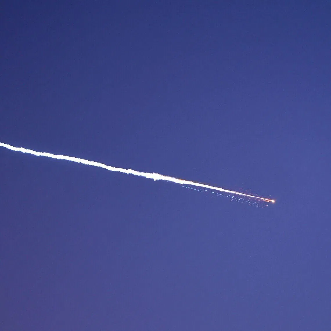 Rocket trails are seen in the sky above the Israeli coastal city of Netanya on March 28.