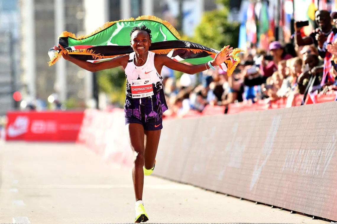 FILE PHOTO: Oct 13, 2024; Chicago, IL, USA; Ruth Chepngetich of Kenya celebrates after finishing first in the women’s race, setting a new world record at 2:09:56 during the Chicago Marathon at Grant Park. Mandatory Credit: Patrick Gorski-Imagn Images/File Photo