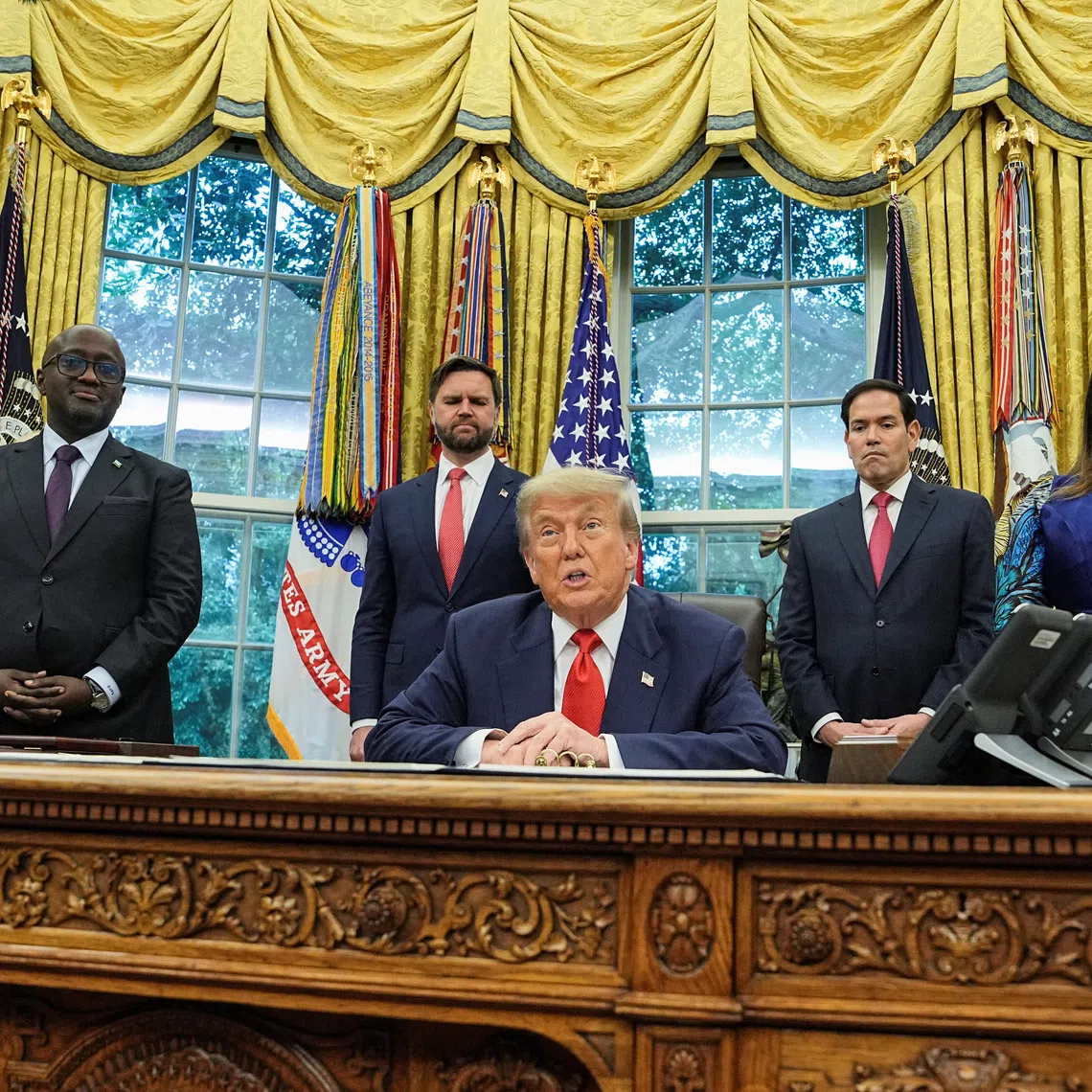 U.S. President Donald Trump speaks during a meeting with Democratic Republic of the Congo's Foreign Minister Therese Kayikwamba Wagner and Rwanda's Foreign Minister Olivier Nduhungirehe in the Oval Office at the White House in Washington D.C., June 27, 2025. REUTERS/Ken Cedeno