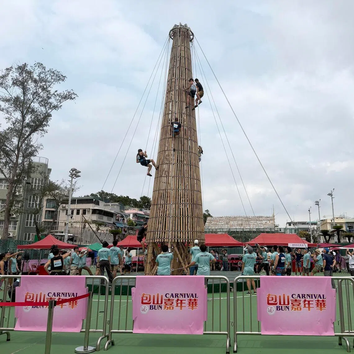 Contestants for Cheung Chau island’s famous “bun-scrambling” competition get to climb the bamboo tower during a training session.