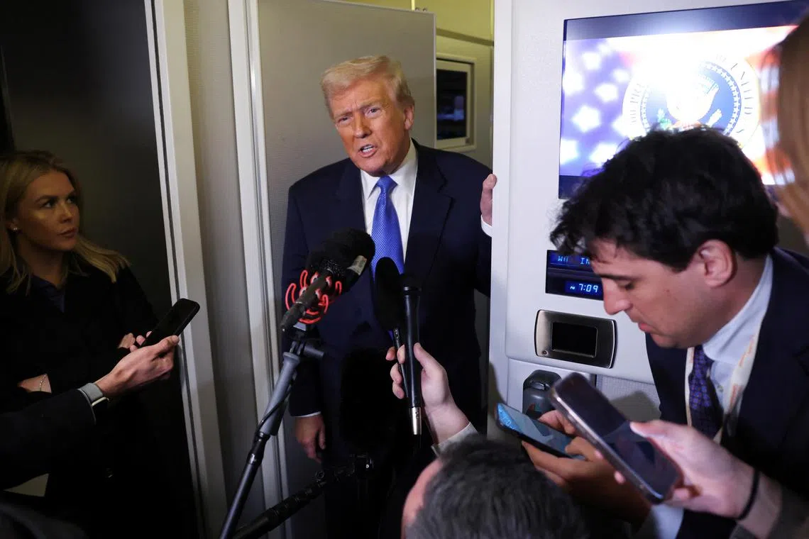 U.S. President Donald Trump speaks to reporters aboard Air Force One on his return to Washington, D.C., U.S., March 9, 2025.  REUTERS/Kevin Lamarque