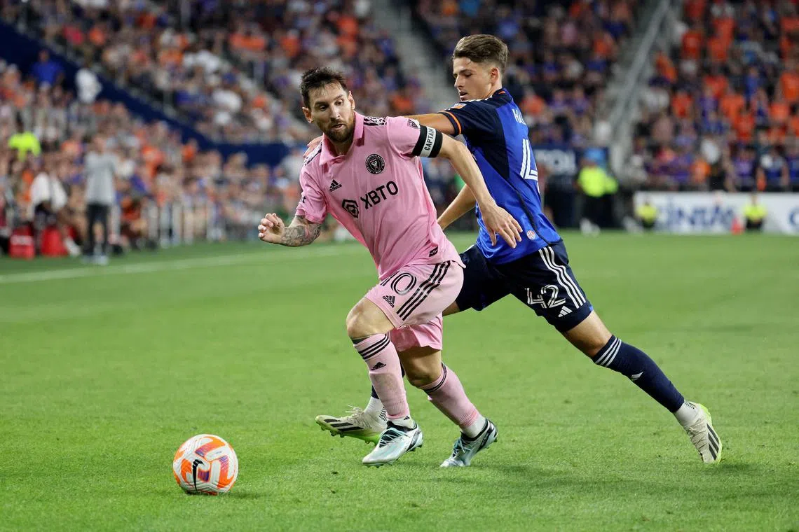 Lionel Messi of Inter Miami controlling the ball against Bret Halsey of Cincinnati during extra time in the US Open Cup semifinal match at TQL Stadium.
