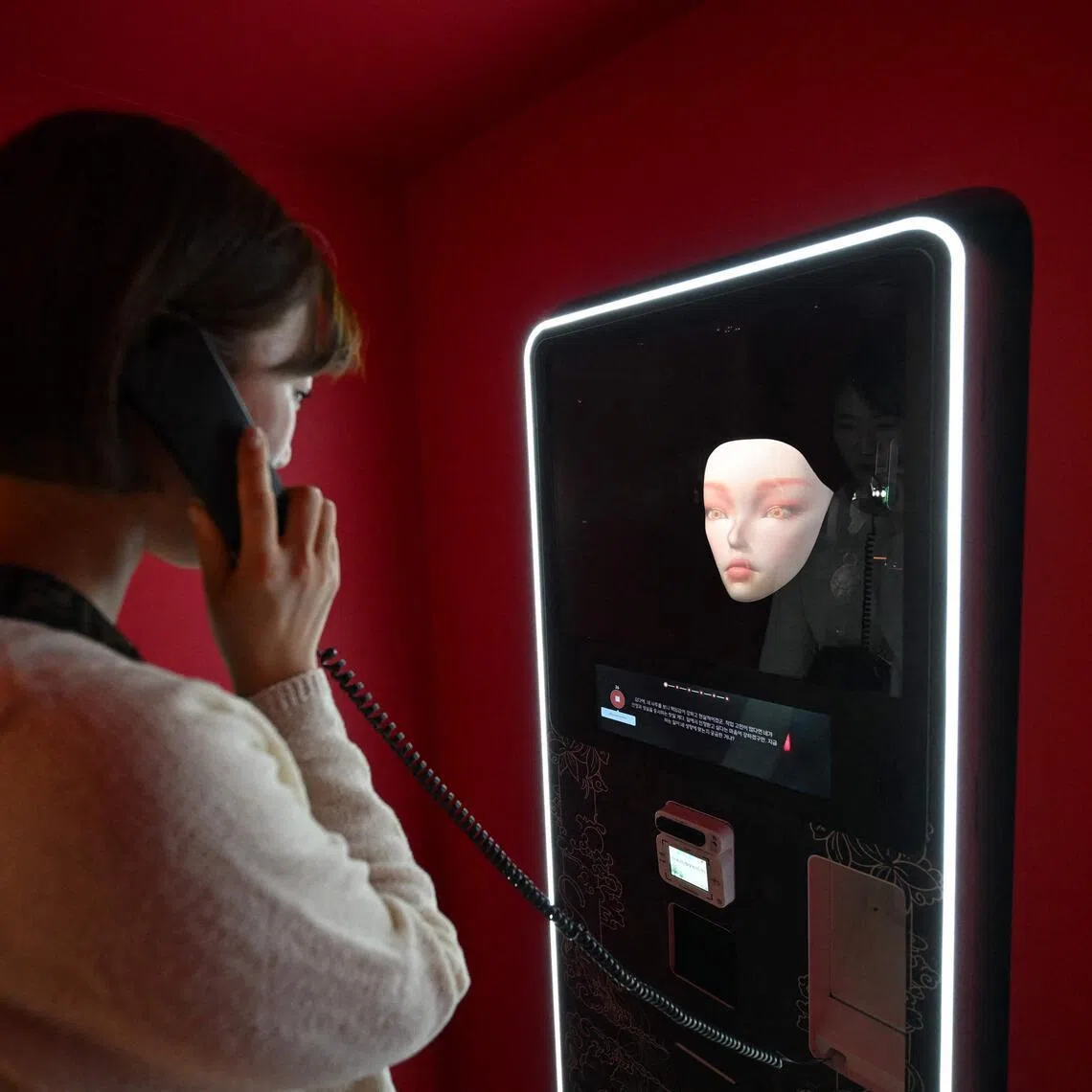 A woman speaks with an artificial intelligence-assisted shaman robot on display in a machine in Seoul, South Korea, on April 15. 