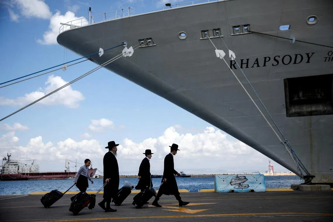 Ultra-Orthodox Jewish carrying their belongings before boarding a ship for U.S. nationals and their immediate family members, as they leave Israel for Cyprus, amid the ongoing conflict between Israel and the Palestinian Islamist group Hamas, in Haifa, Israel on Oct 16.     
