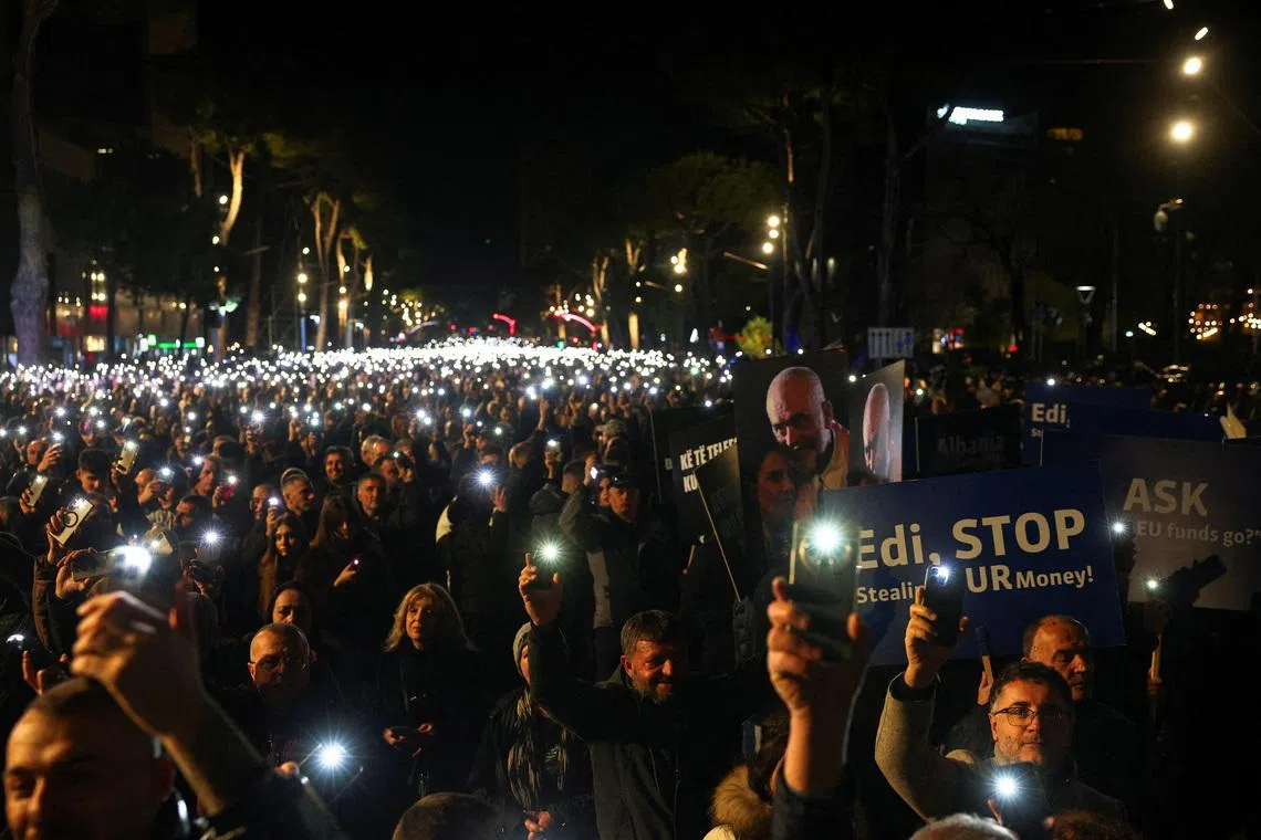 FILE PHOTO: Supporters of the Albanian opposition hold lights aloft during an anti-government protest, triggered by a corruption investigation into Deputy Prime Minister Belinda Balluku, near the Prime Minister's office in Tirana, Albania, January 24, 2026. REUTERS/Florion Goga/File Photo