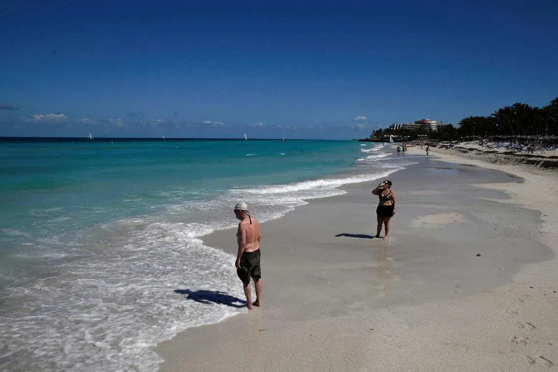 Tourists walk on the beach, as the U.S. blocks shipments of oil from reaching the island nation, in Varadero, Cuba February 10, 2026. REUTERS/Norlys Perez