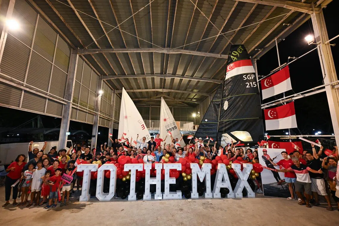 Supporters of Maximilian Maeder taking a group photograph at National Sailing Centre after the final is postponed.